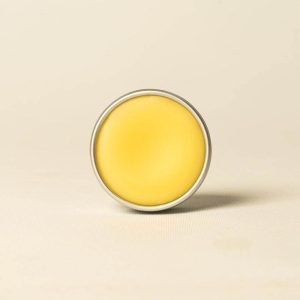 Open tin of Bee Cosmetics beeswax lip balm sold by East Anglia Apiaries