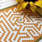 Close-up of a honeycomb sticker activity inside the Discover Bees book