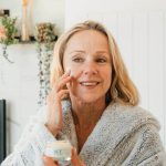 Woman applying Bee Cosmetics rejuvenating facial cream to her cheek
