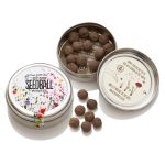 Collection of Seedball pollinator seed tins with one open tin of seed balls