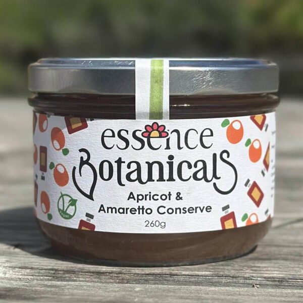 Essence Botanicals apricot and amaretto conserve jar on a wooden surface