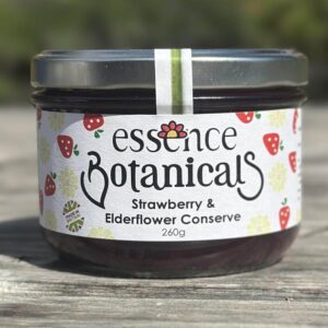 Essence Botanicals strawberry and elderflower conserve jar on a wooden surface