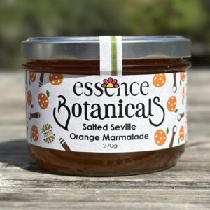 Essence Botanicals salted Seville orange marmalade jar on a wooden surface