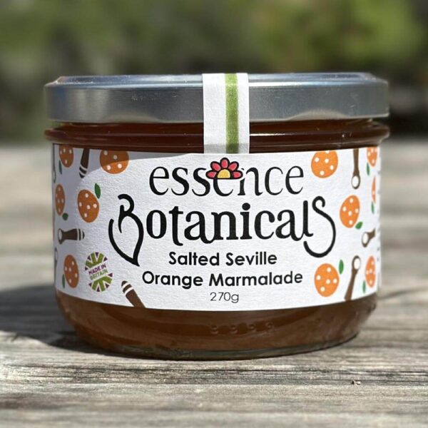Essence Botanicals salted Seville orange marmalade jar on a wooden surface